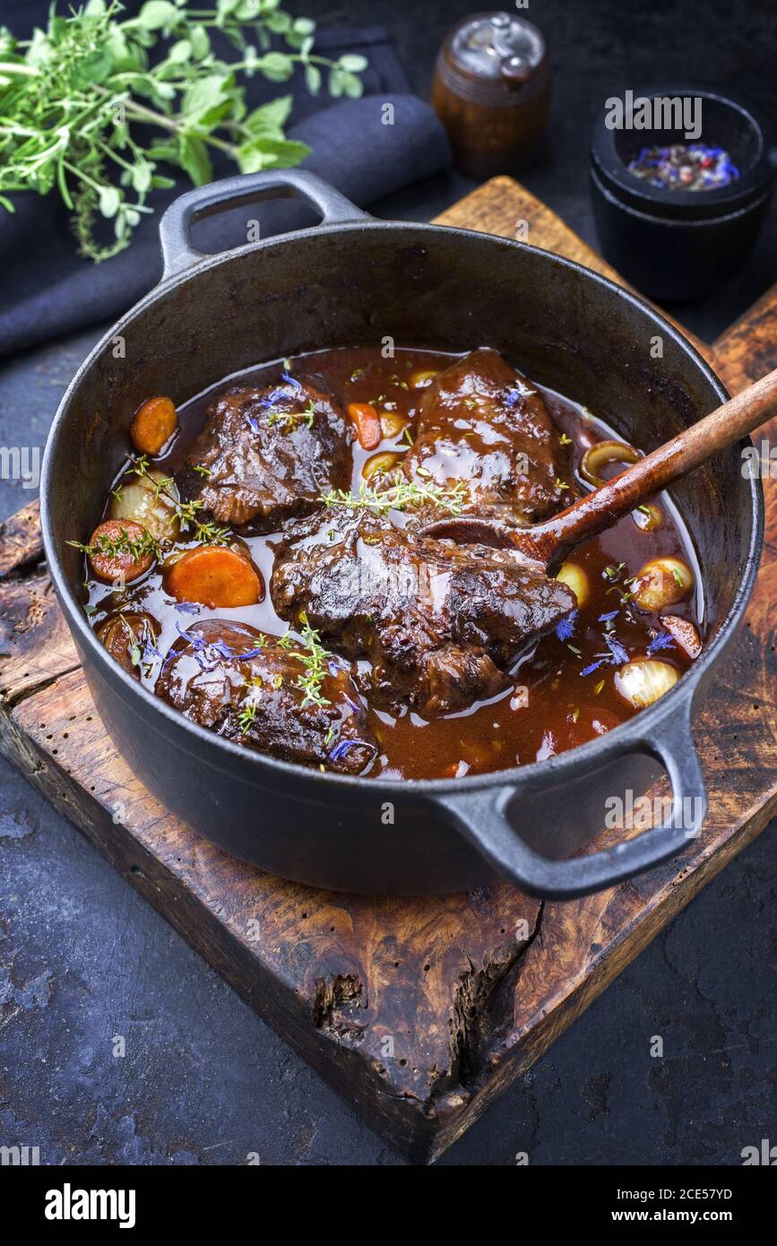 Traditional German braised beef cheeks in brown red wine sauce with
