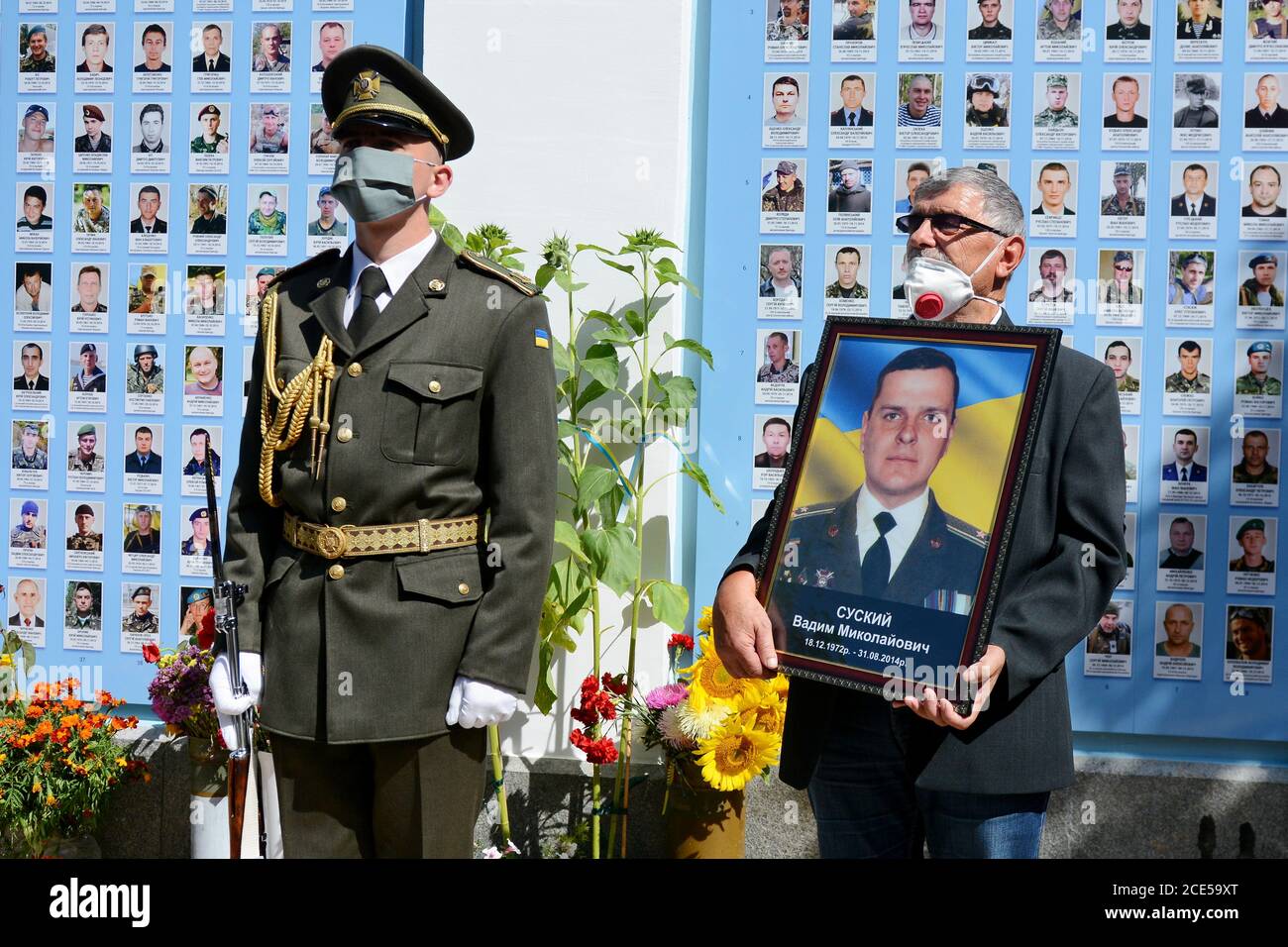 Kyiv, Ukraine. 29th Aug, 2020. A man holds a portrait of his son next to the near the memorial wall to the soldiers who died as a result of the artillery shelling of the Russian military in eastern Ukraine during a commemorative ceremony dedicated to the Day of Remembrance of the Defenders of Ukraine and the 6th anniversary of the Ilovaisk battle in Kiev, Ukraine, August 29, 2020. (Photo by Aleksandr Gusev/Pacific Press/Sipa USA) Credit: Sipa USA/Alamy Live News Stock Photo