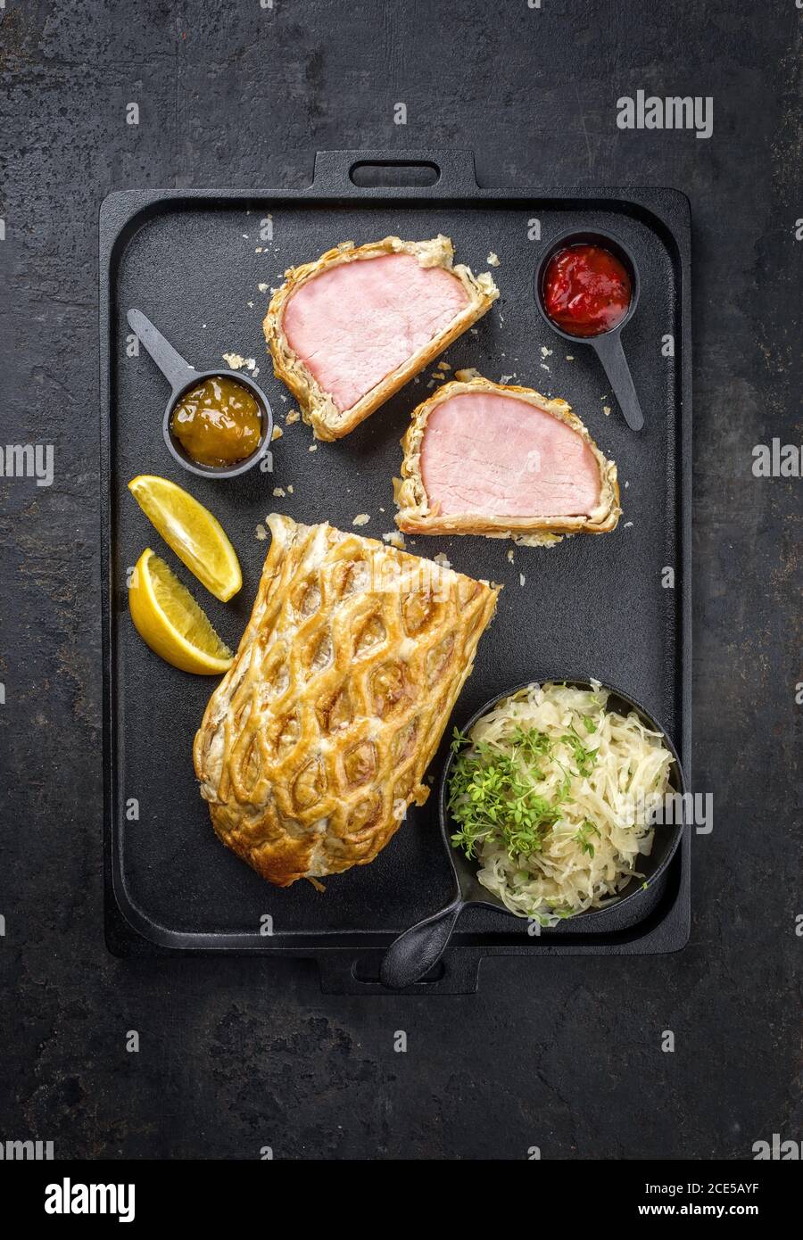 Backed Kasseler pork steak with sauerkraut Stock Photo Alamy