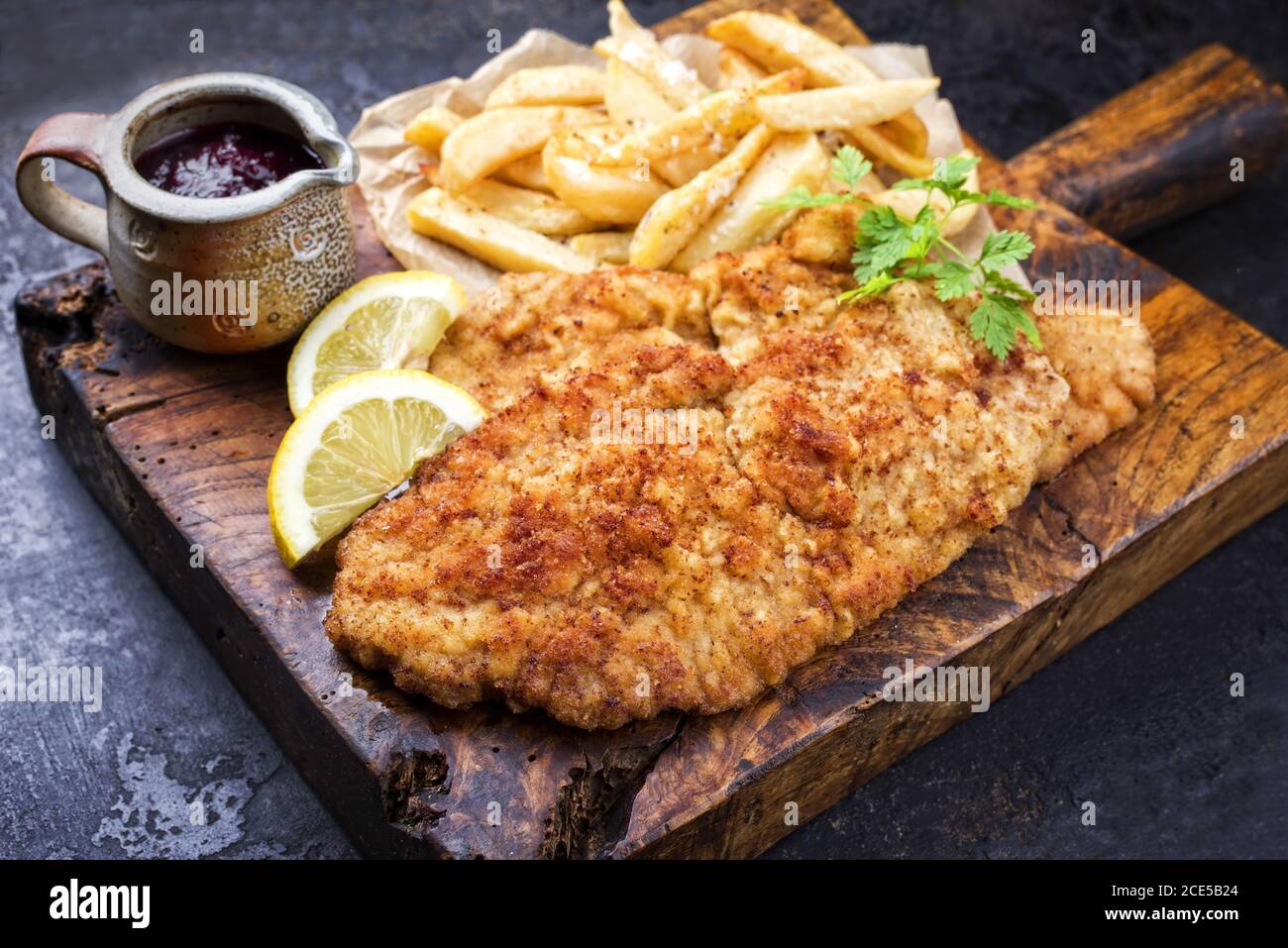 Fried Wiener schnitzel from veal topside with French fries and lemon
