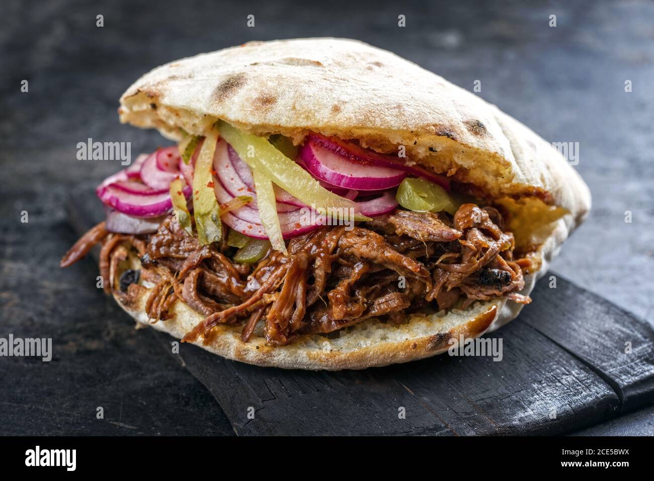 Traditional barbecue pulled beef burger offered with Carolina BBQ sauce Stock Photo Alamy