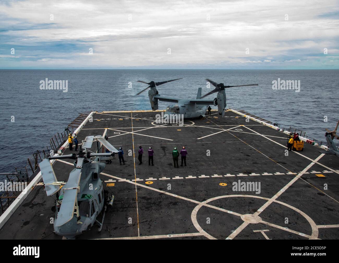 PHILIPPINE SEA (Aug. 22, 2020) Equipment is offloaded from an MV-22B Osprey tiltrotor aircraft with Marine Medium Tiltrotor Squadron 262 (Reinforced), 31st Marine Expeditionary Unit (MEU), aboard USS New Orleans (LPD 18). New Orleans, part of the America Amphibious Ready Group (ARG), 31st MEU team, is operating in the U.S. 7th Fleet area of operation to enhance interoperability with allies and partners and serve as a ready response force to defend peace and stability in the Indo-Pacific region. The America ARG, 31st MEU team remains the premier crisis response force in the region despite the u Stock Photo