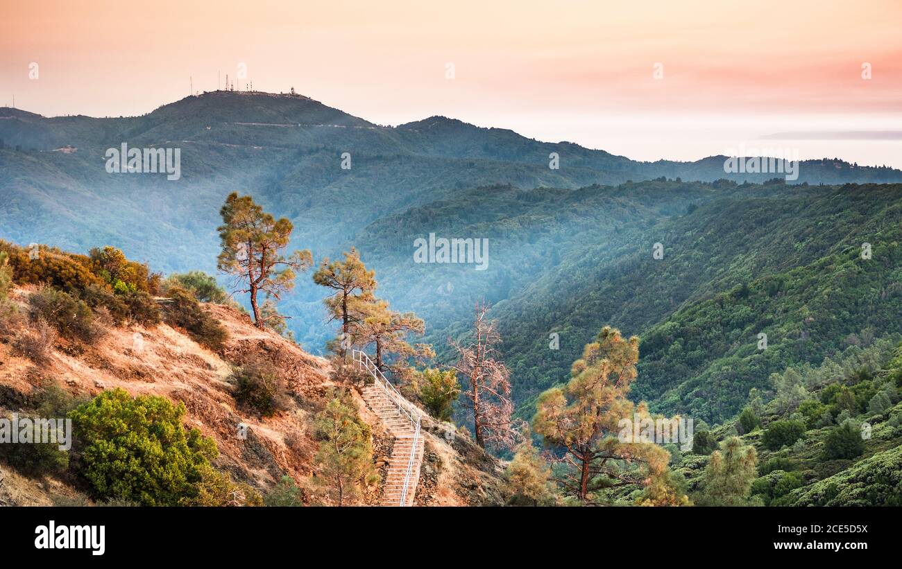 Sunset views in Santa Cruz mountains; Smoke from the nearby burning wildfires, visible in the air and covering the mountain ridges and valleys; South Stock Photo