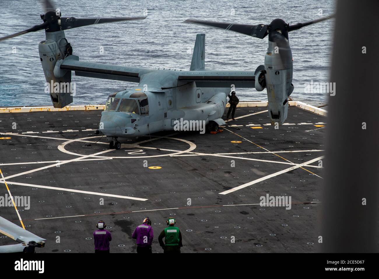 PHILIPPINE SEA (Aug. 22, 2020) Equipment is offloaded from an MV-22B Osprey tiltrotor aircraft with Marine Medium Tiltrotor Squadron 262 (Reinforced), 31st Marine Expeditionary Unit (MEU) aboard USS New Orleans (LPD 18). New Orleans, part of the America Amphibious Ready Group (ARG), 31st MEU team, is operating in the U.S. 7th Fleet area of operation to enhance interoperability with allies and partners and serve as a ready response force to defend peace and stability in the Indo-Pacific region. The America ARG, 31st MEU team remains the premier crisis response force in the region despite the un Stock Photo