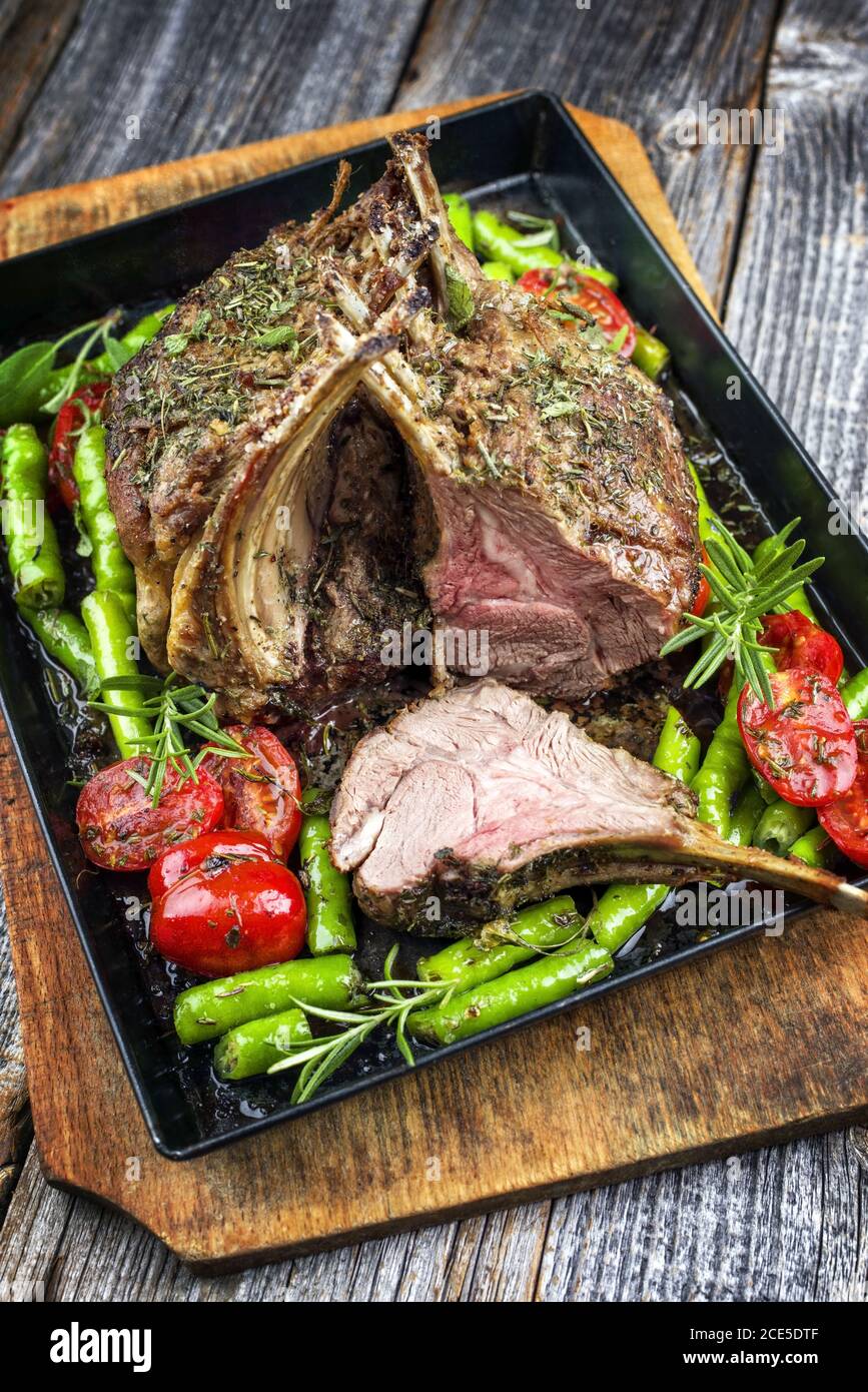 Barbecue rack of lamb neck with paprika and tomato offered as closeup
