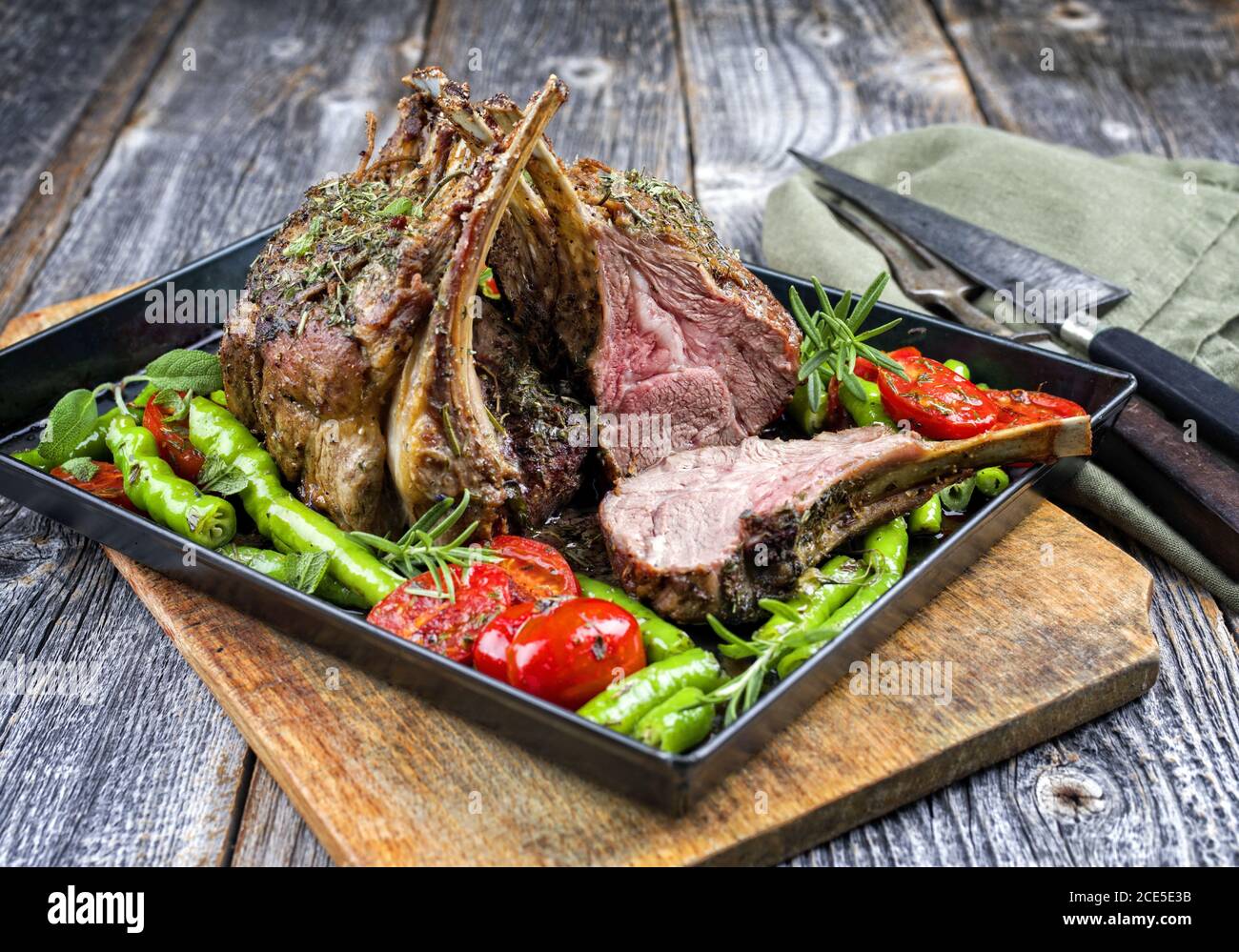 Barbecue rack of lamb neck with paprika and tomato offered as closeup on a metal tray Stock