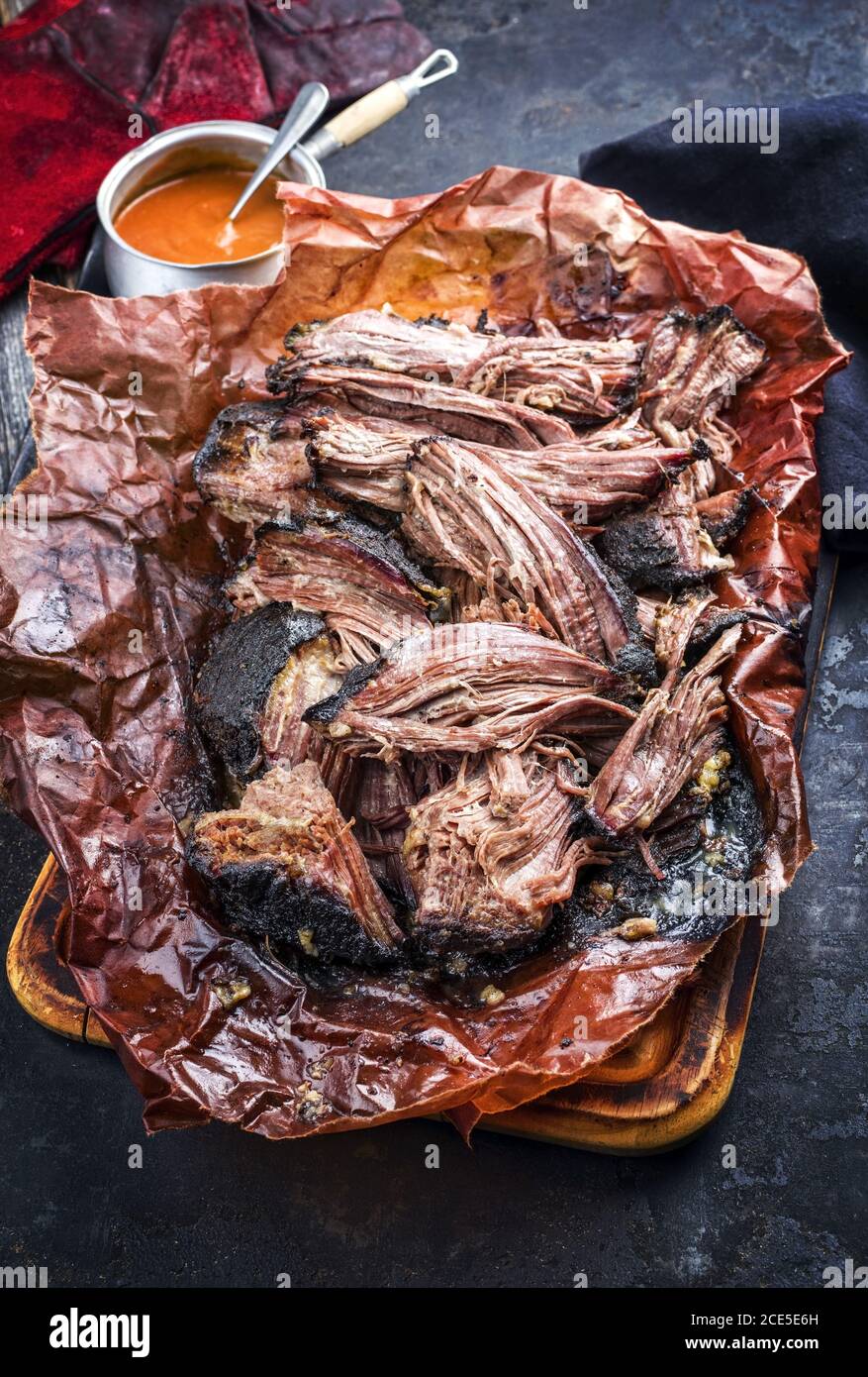 Traditional barbecue wagyu pulled beef in peach paper with Carolina BBQ