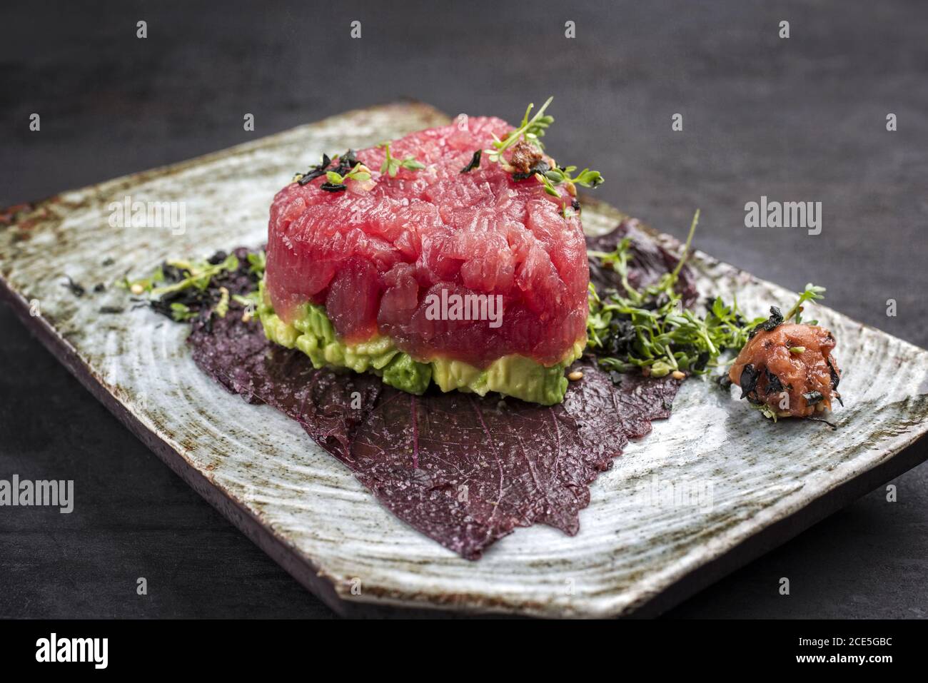 Gourmet fish tartar raw from tuna fillet with hashed avocado Stock Photo