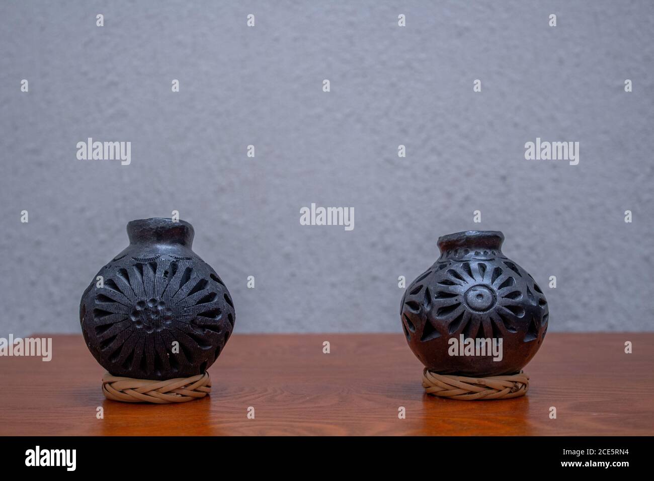 Mexican crafts made with black clay from Oaxaca Mexico. above wood on isolated white background Stock Photo