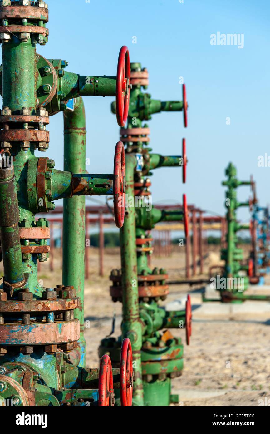 Petroleum well wellhead equipment. Hand valve with handwheel on the flow  line. Oilfield site. Oil, gas industry concept. Industr Stock Photo - Alamy