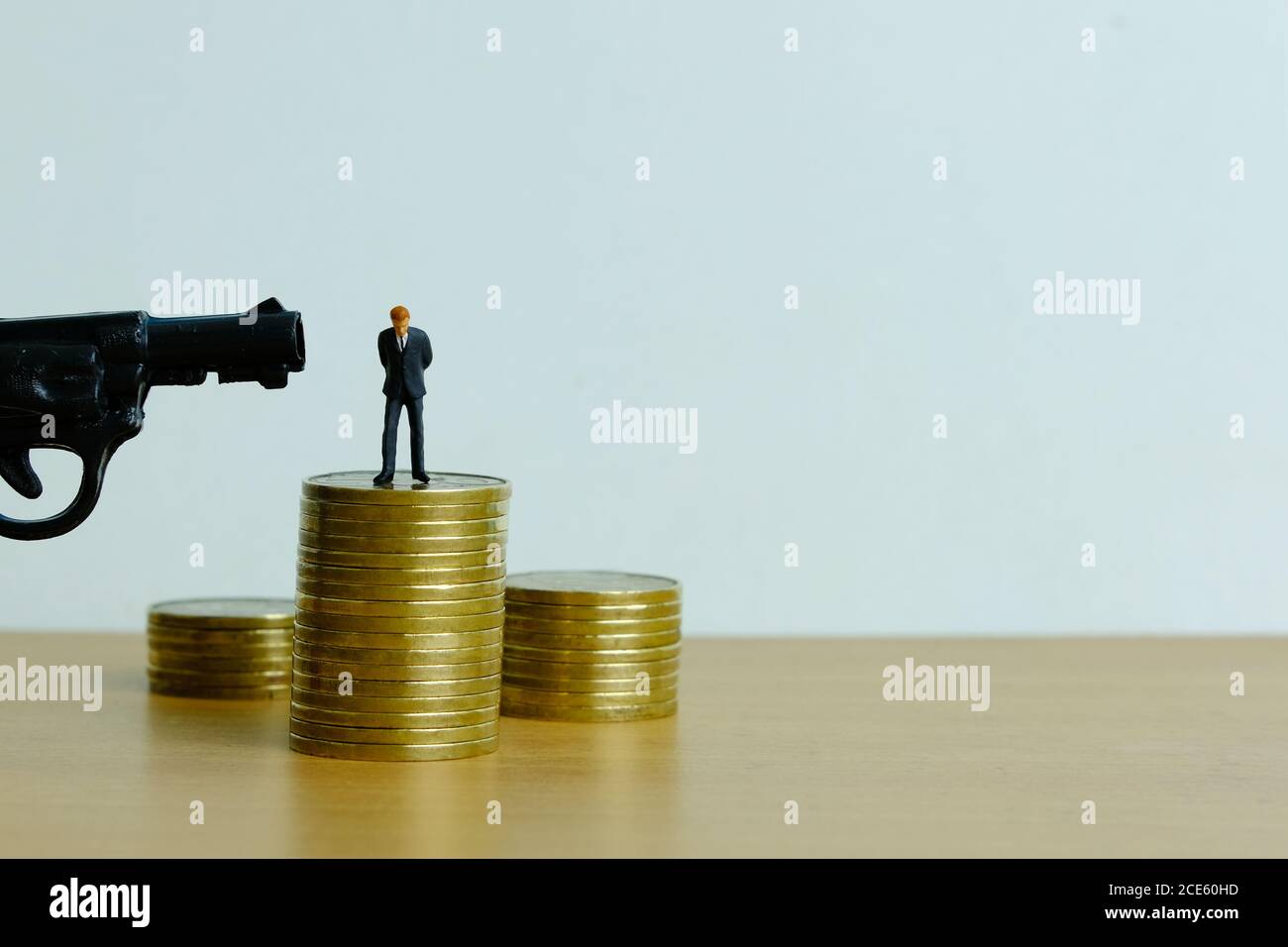 Miniature people concept - businessman thinking to death for debt solution Stock Photo