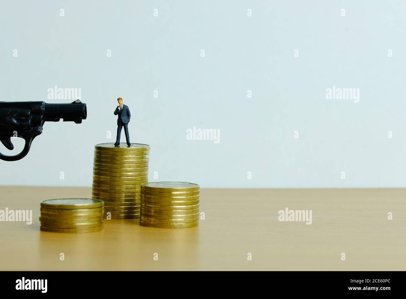 Miniature people concept - businessman thinking to death for debt solution Stock Photo