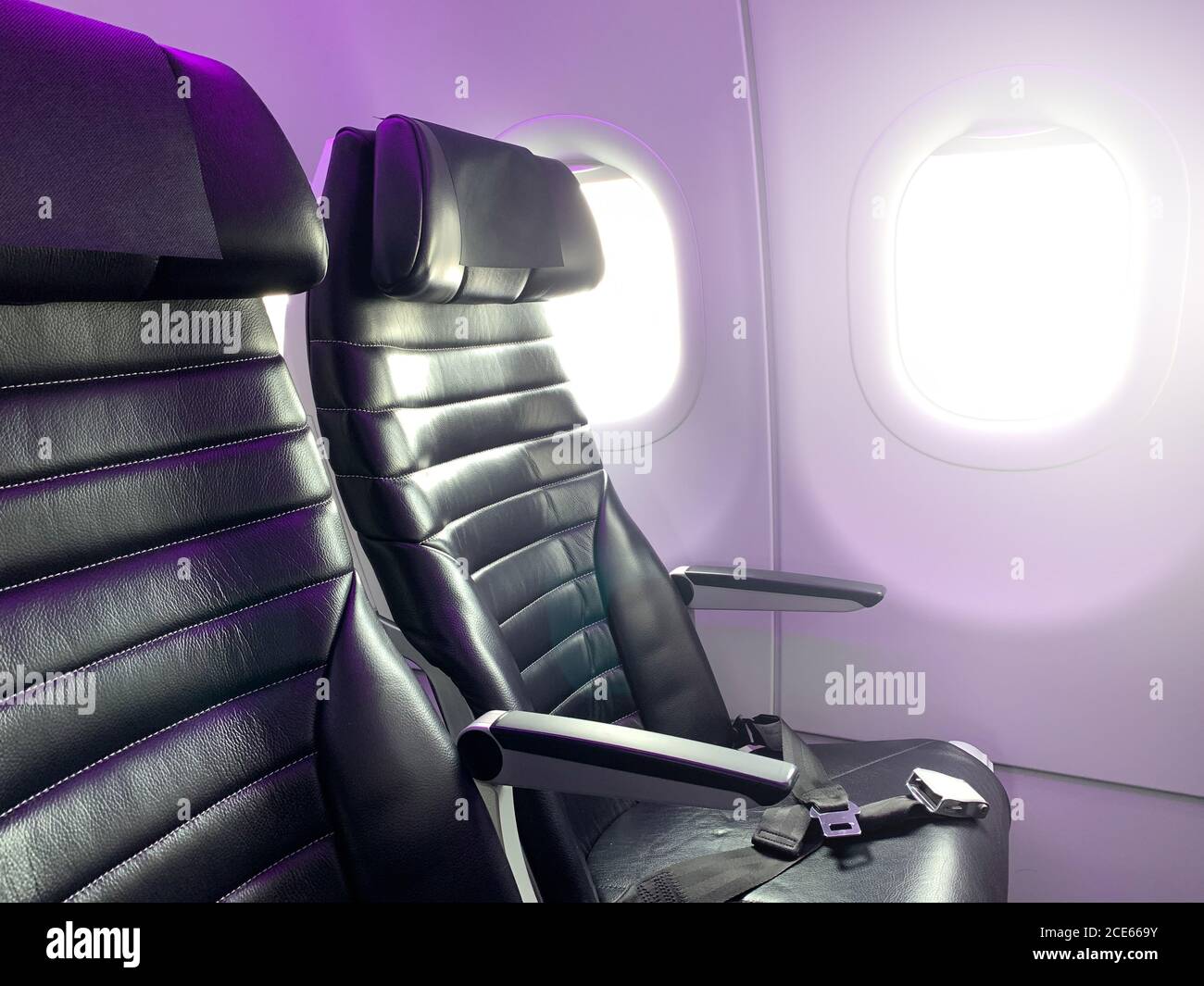 Airplane seats in the cabin economy class. Stock Photo