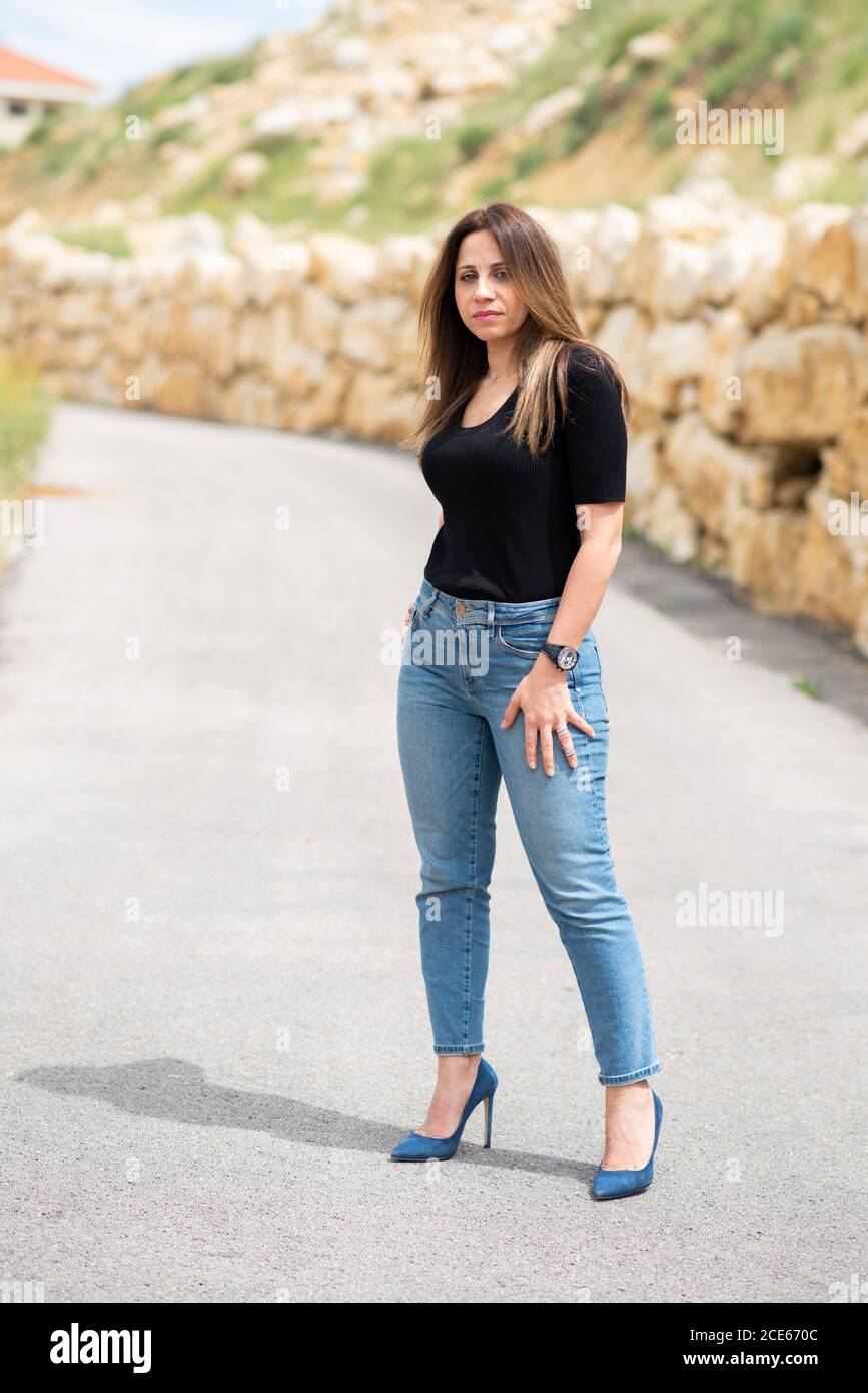 Beautiful woman wearing jeans standing in the street Stock Photo - Alamy