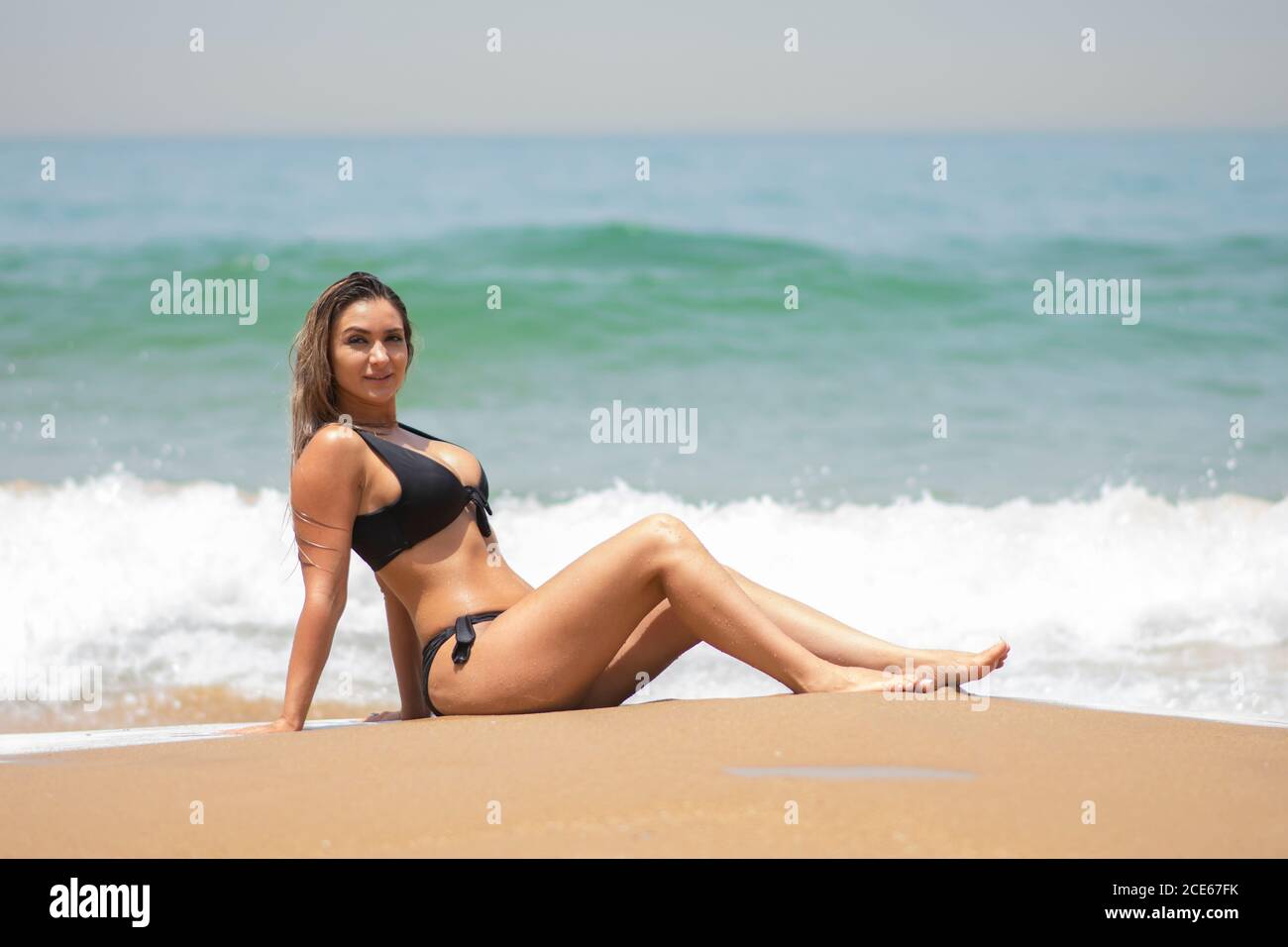 Woman in bikini relaxing on the beach Stock Photo