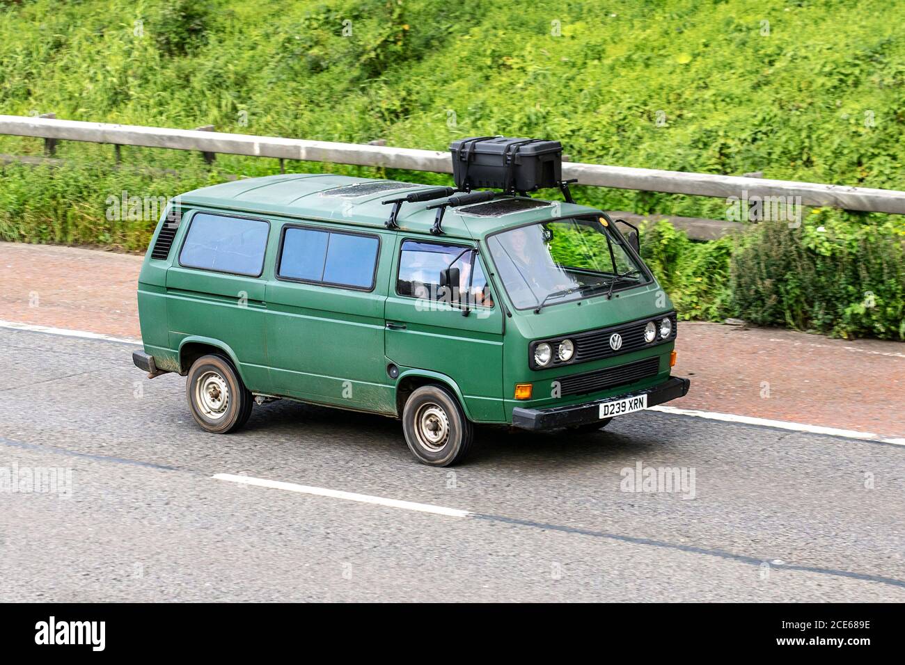 1997 90s green Volkswagen Transporter 78Ps; Caravans and Motorhomes, campervans on Britain's roads, RV leisure vehicle, family holidays, caravanette vacations, Touring caravan holiday, van conversions, Vanagon autohome, life on the road, Bay Window Dormobile Stock Photo