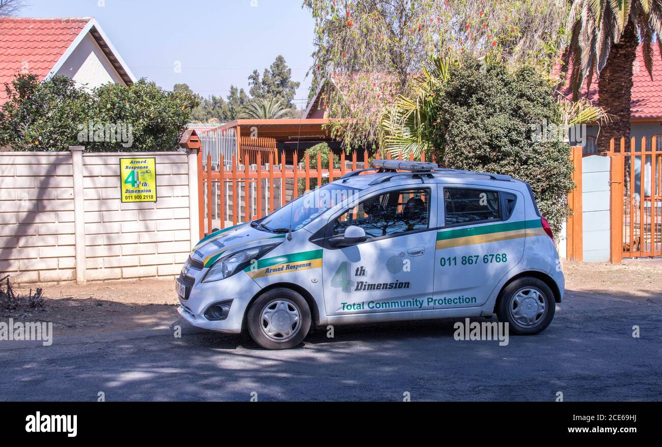Alberton, South Africa - a private security company vehicle patrols outside a private house in a time of high crime image in horizontal format Stock Photo