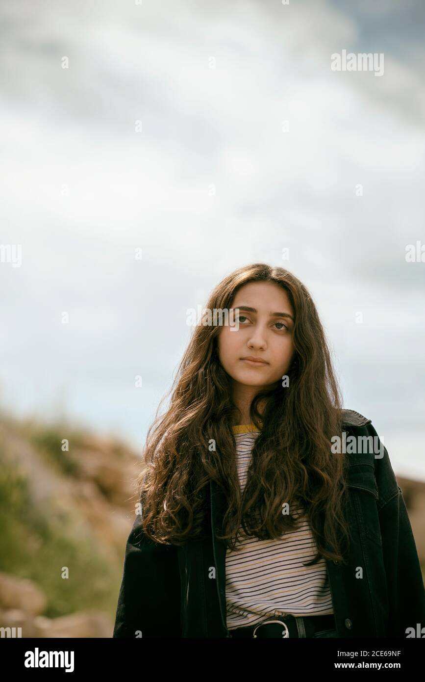 Beautiful teenage girl looking away outdoors Stock Photo - Alamy