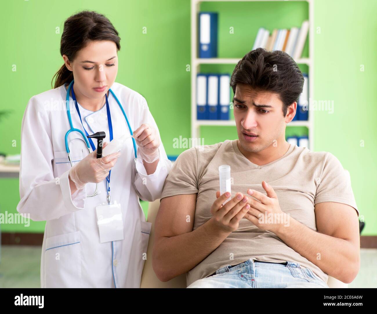 The female doctor checking patient's ear during medical examination ...