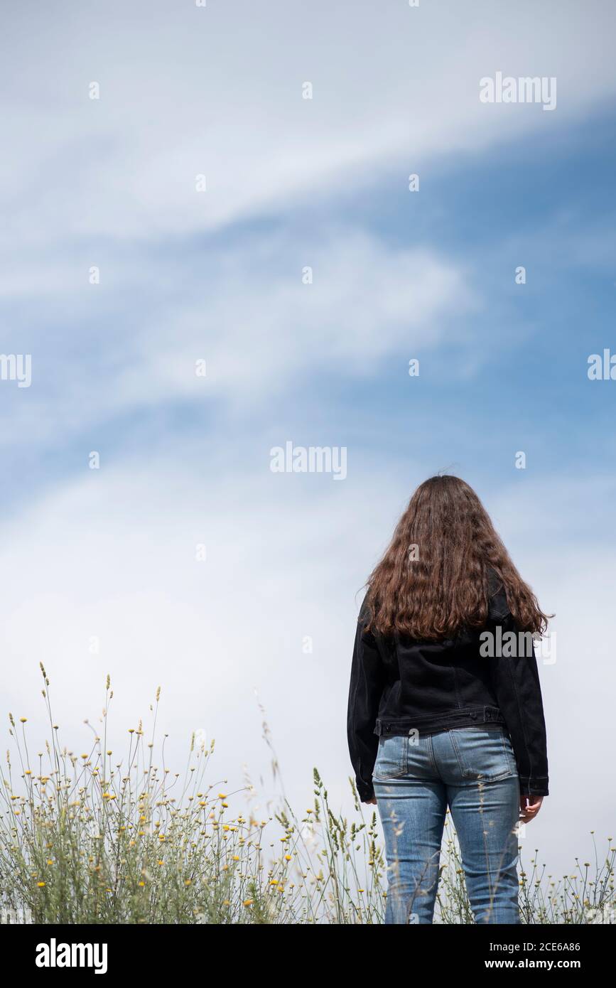 Rear view of teenage girl standing outdoors Stock Photo - Alamy