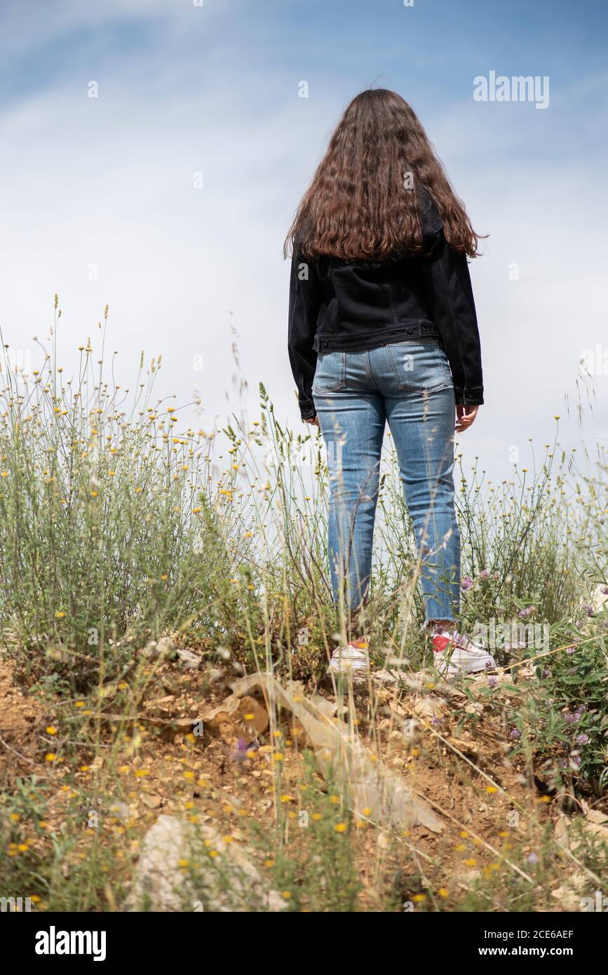 Rear view of teenage girl standing outdoors Stock Photo - Alamy