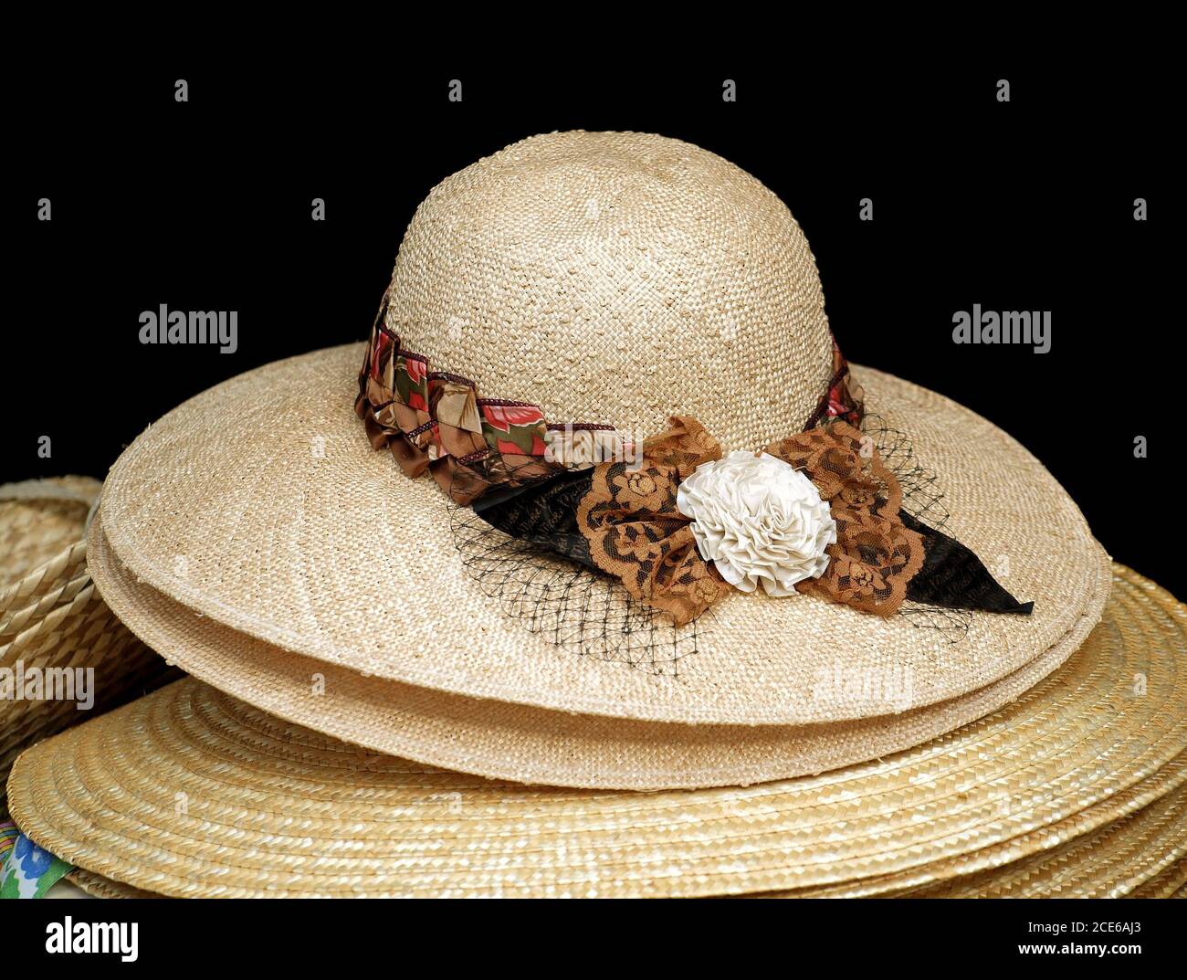 Handmade straw hats with colorful ribbons are on display Stock Photo