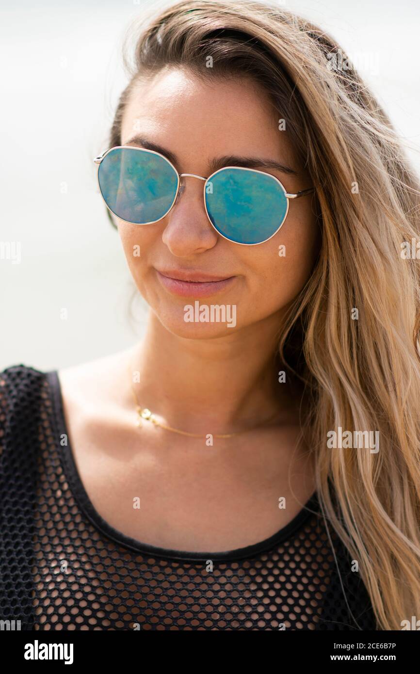 Beautiful woman wearing sunglasses by the beach Stock Photo