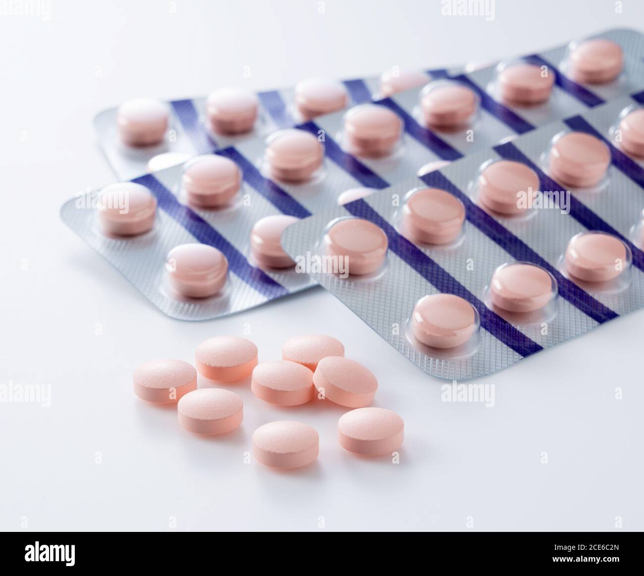 Pink pills placed on a white background Stock Photo