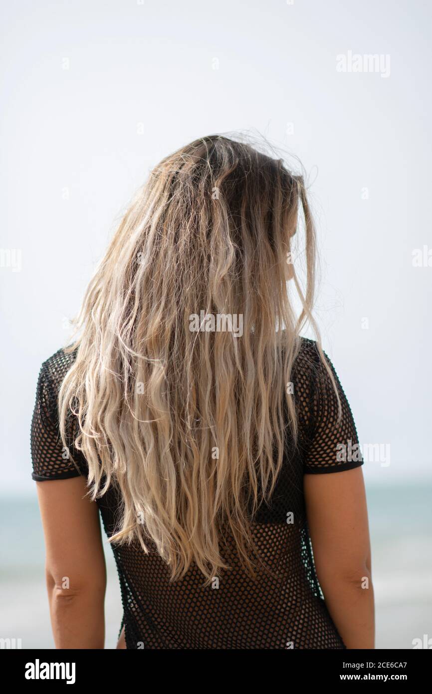 Rear view of woman on the beach Stock Photo