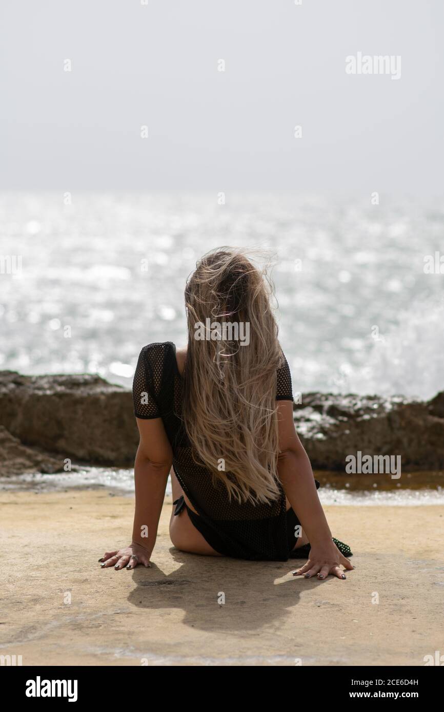 Woman relaxing on the beach Stock Photo