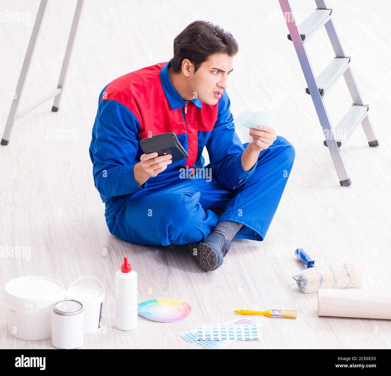 The young painter trying to match colours for painting job Stock Photo