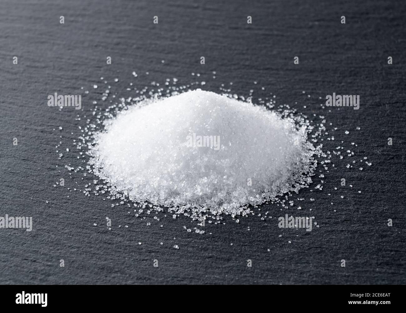 Sugar placed on a black stone plate Stock Photo