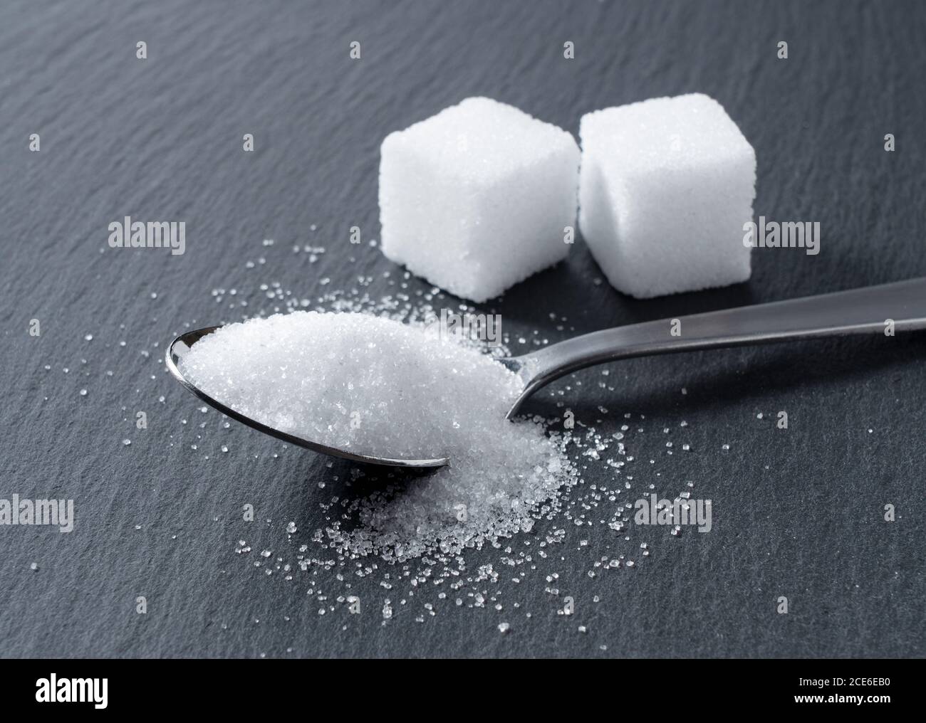 Sugar placed on a black stone plate Stock Photo