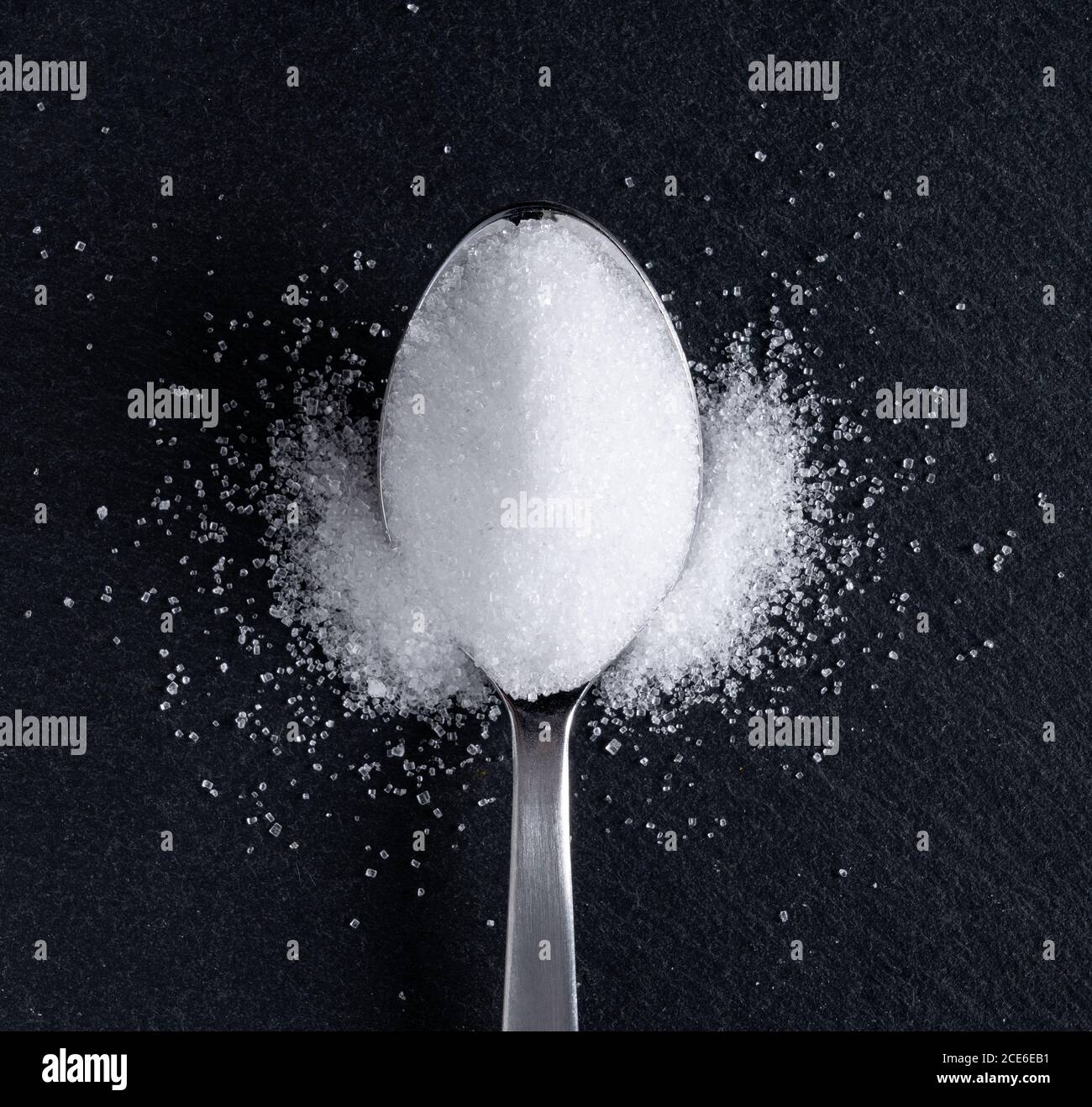 Sugar placed on a black stone plate Stock Photo