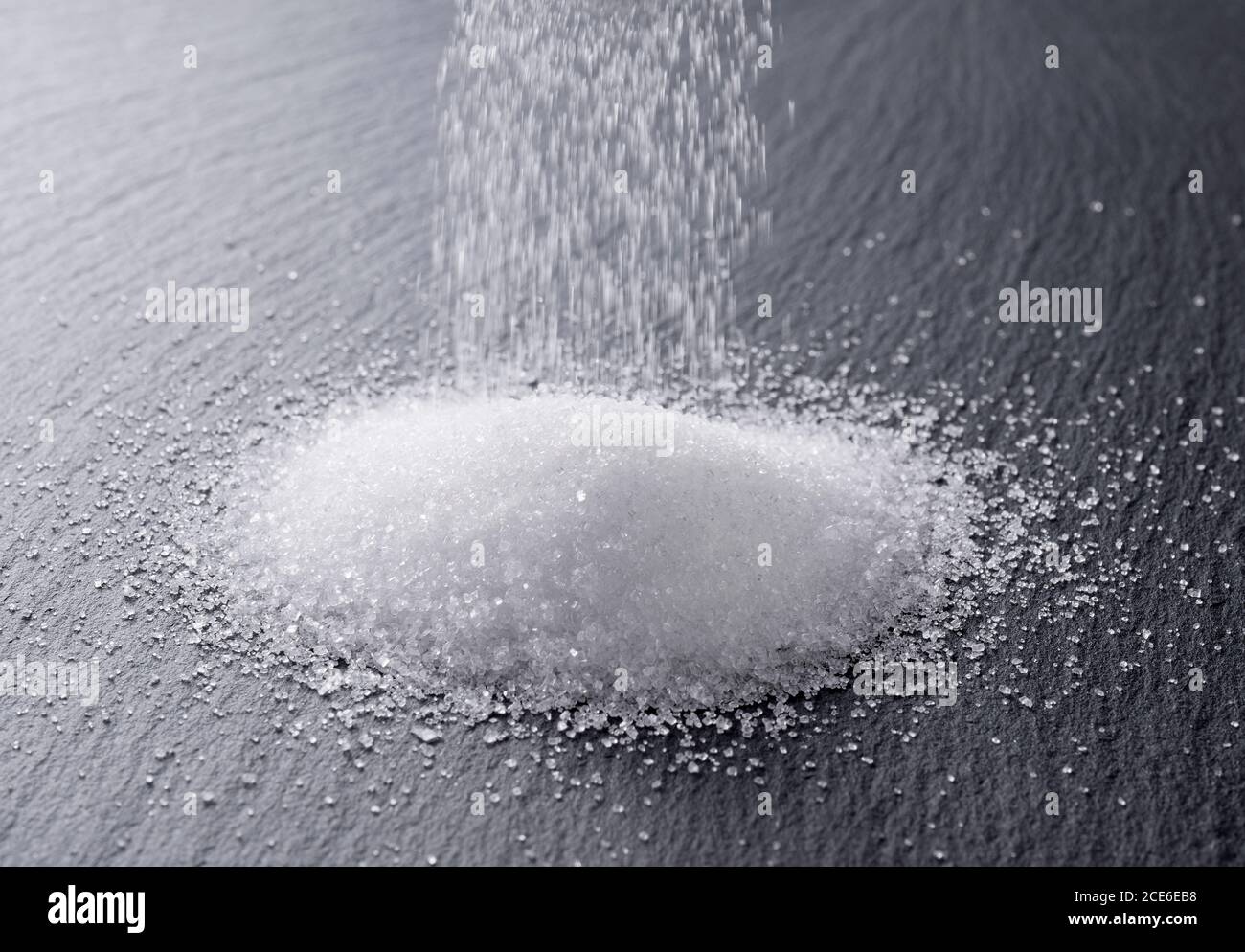 Sugar placed on a black stone plate Stock Photo