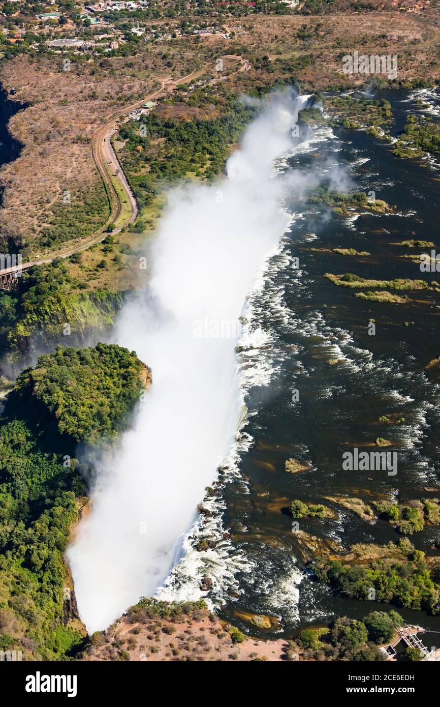 Victoria Falls and Zambezi River, Mosi-oa-Tunya, one of the world's largest waterfalls, Aerial view by helicopter, Zambia, Zimbabwe, border, Africa Stock Photo