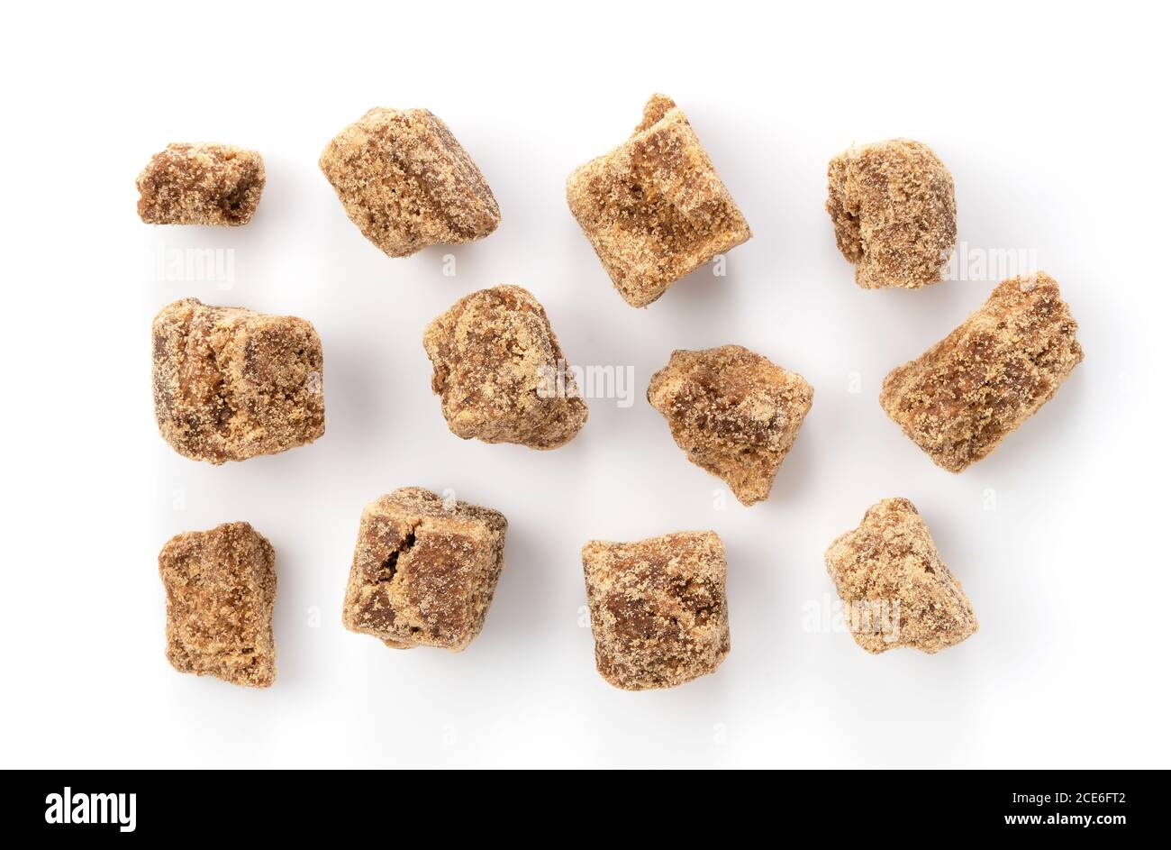 Take a bird's-eye view of brown sugar chunks on a white background Stock Photo