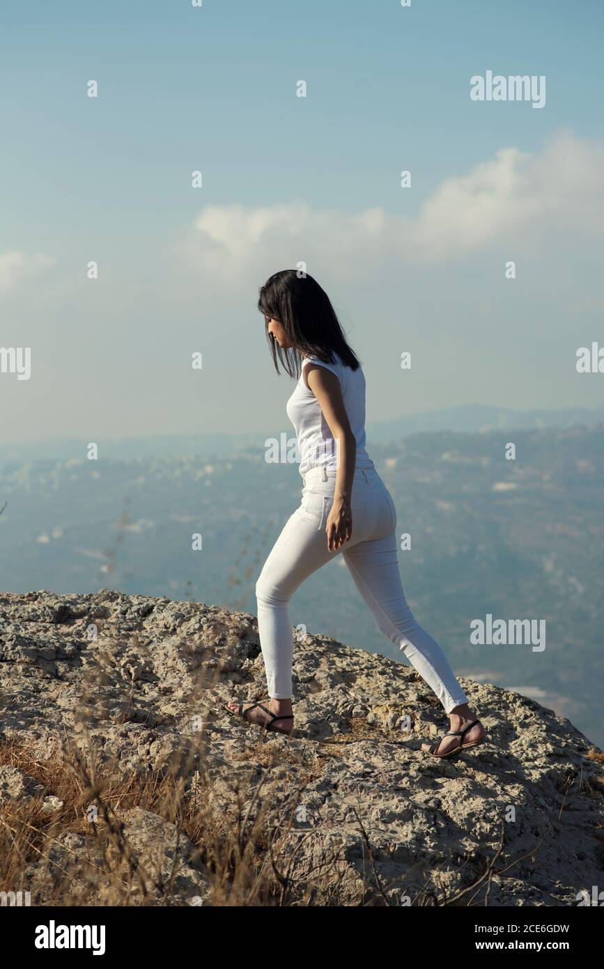 Full length woman walking on the mountain Stock Photo