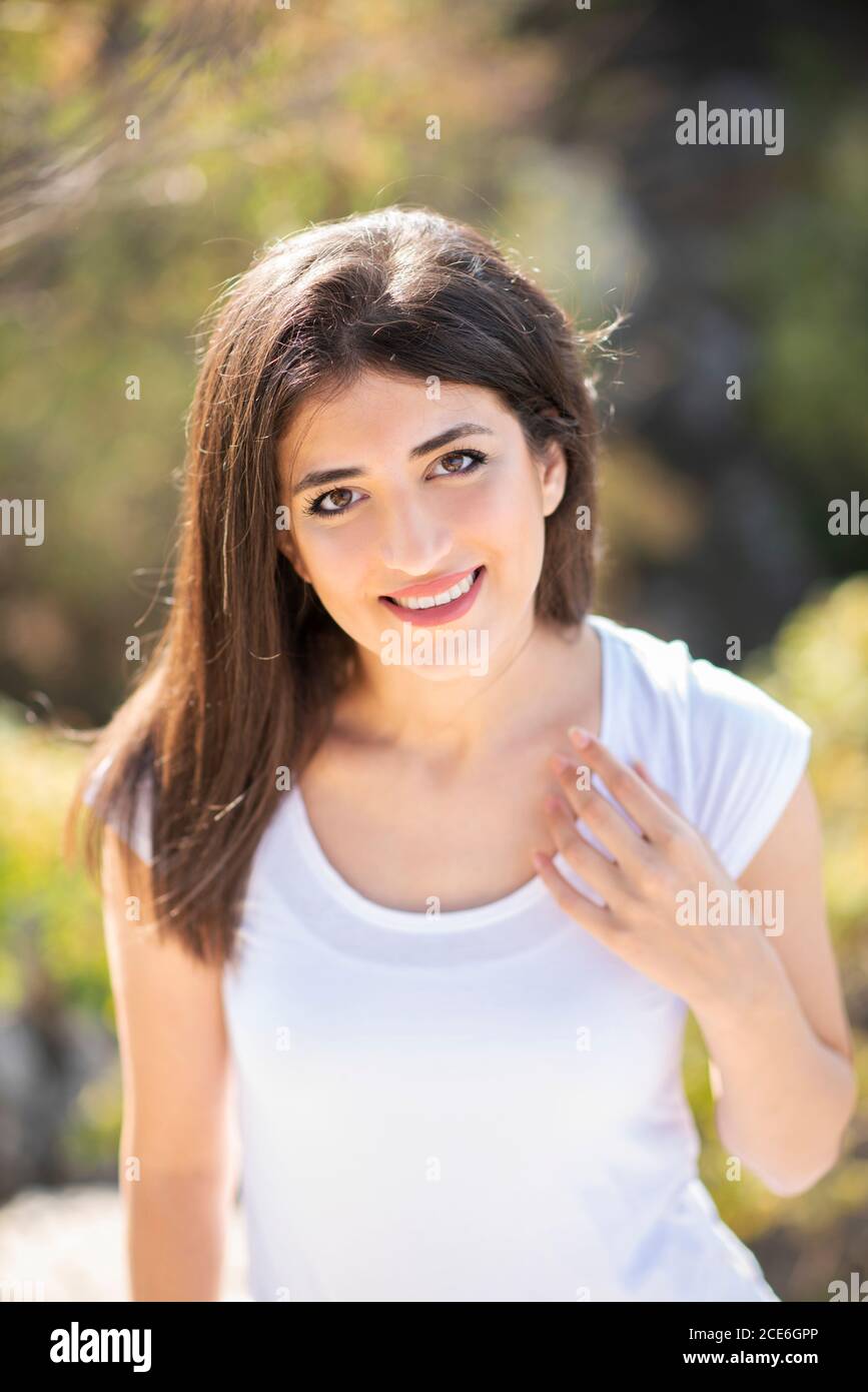 Beautiful young woman smiling outdoors Stock Photo - Alamy