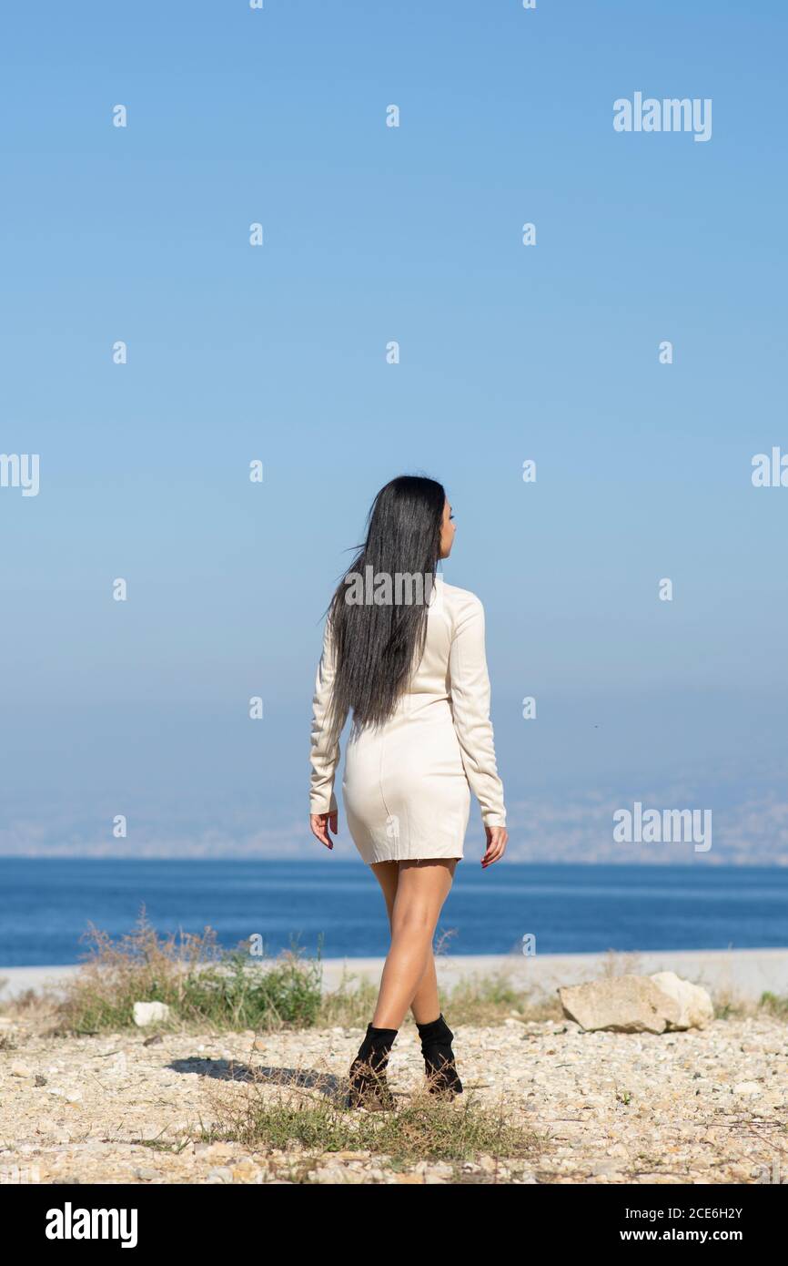 Woman walking by the sea Stock Photo