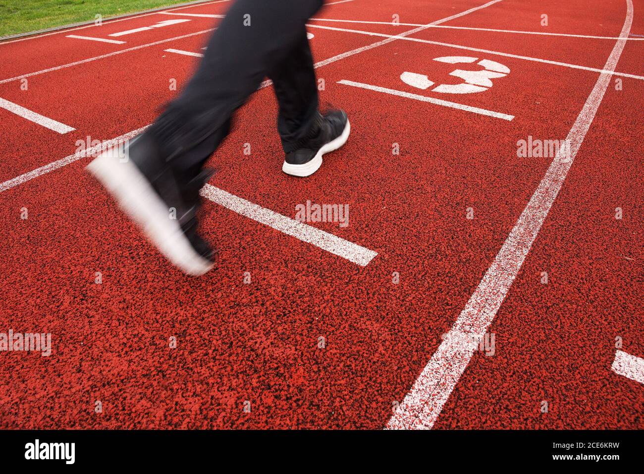 Red running racetrack on the stadium with run legs Stock Photo