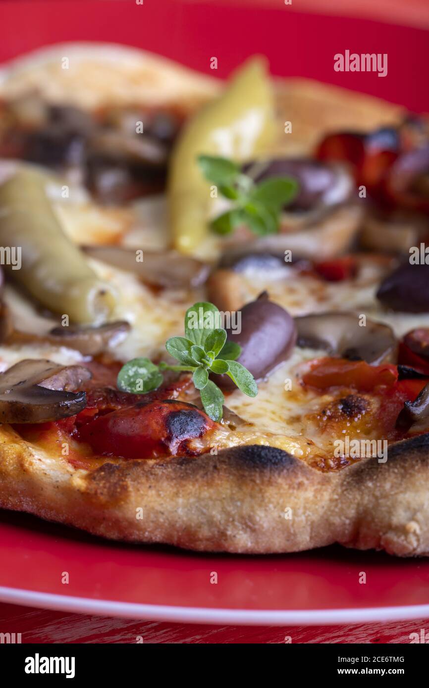 fresh pizza on red background Stock Photo