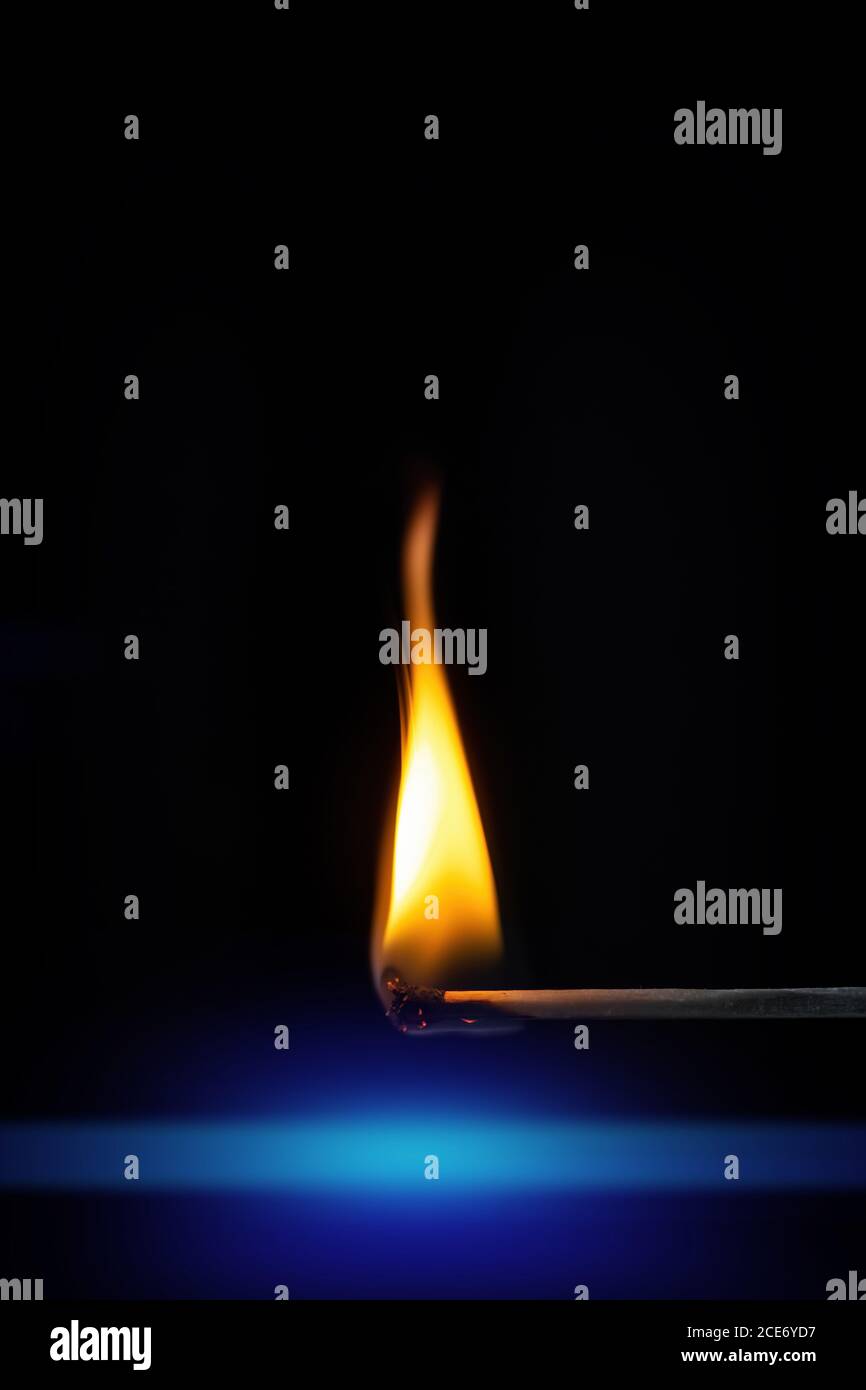match stick flame in front of a black background Stock Photo