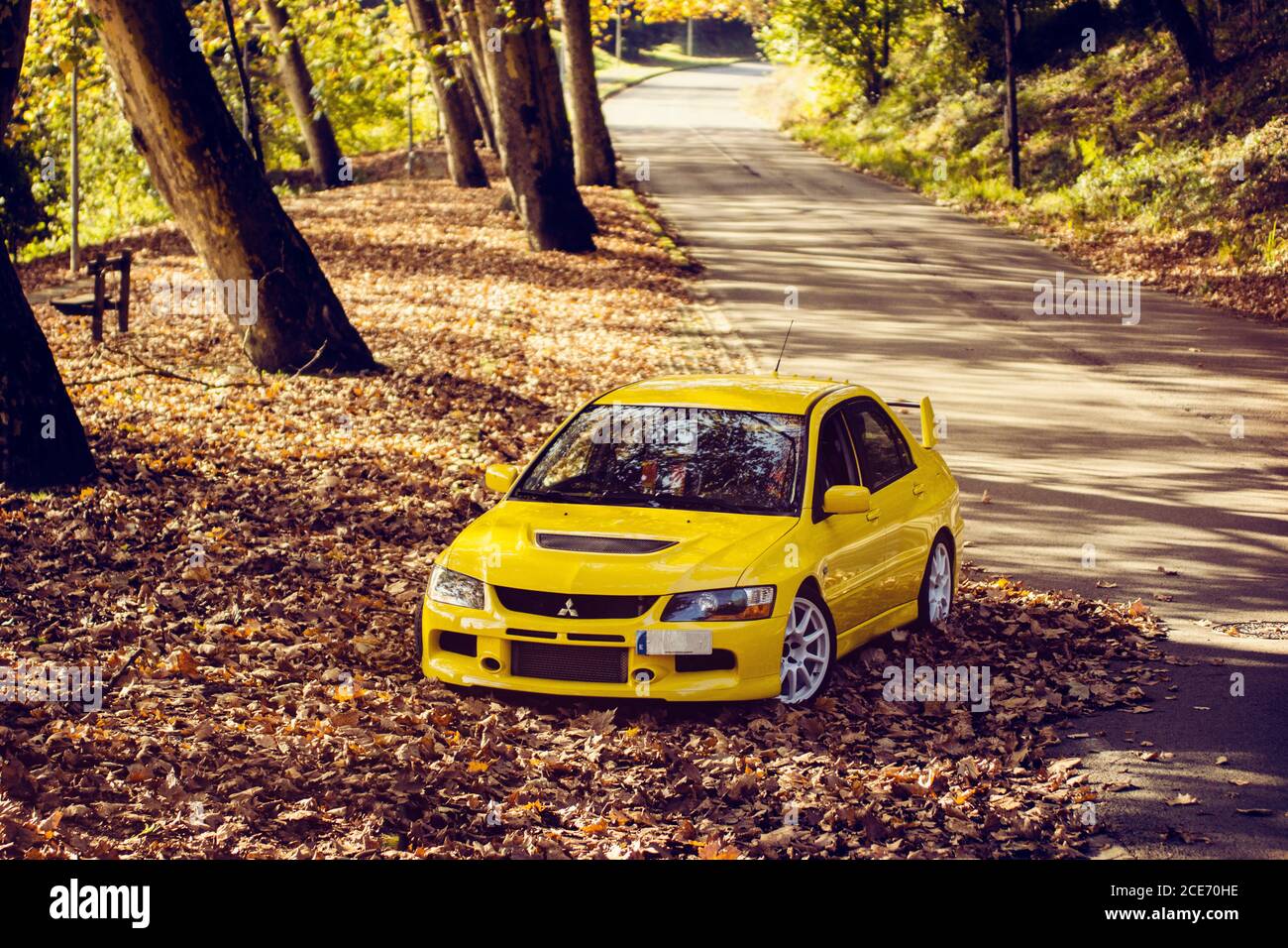 Mitsubishi Lancer Evolution 9 Shot In A Mountain Road Full Of Autumn Leaves Stock Photo Alamy