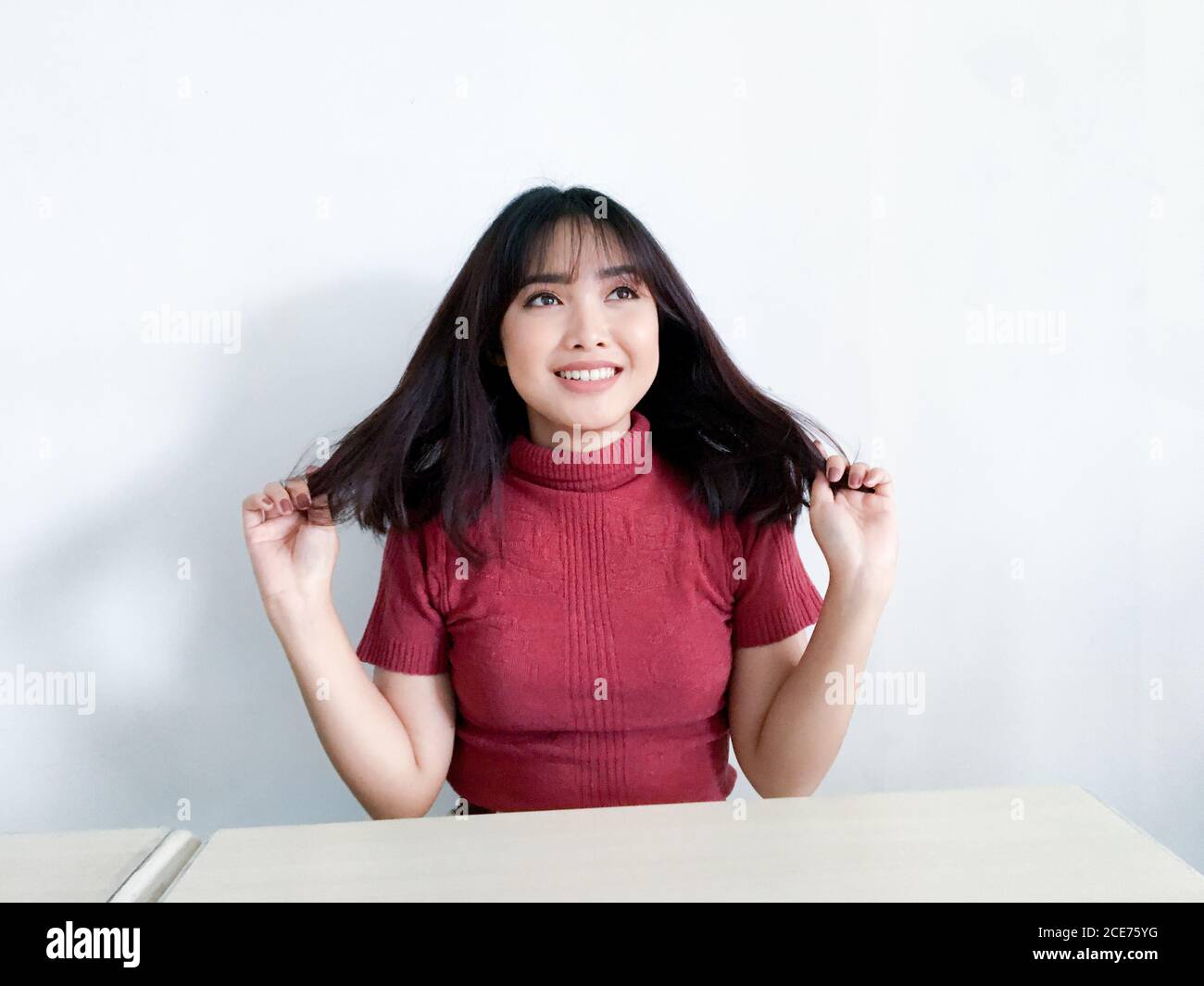 Wow and shocked face of beautiful Young Asian girl with hand touching chest wear red shirt. Advertising model concept. Stock Photo