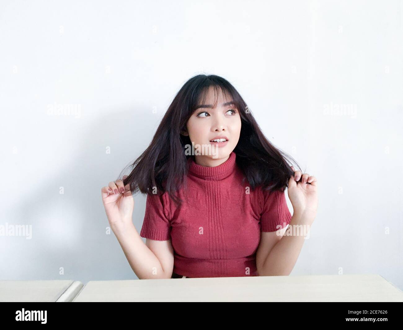 Wow and shocked face of beautiful Young Asian girl with hand touching chest wear red shirt. Advertising model concept. Stock Photo