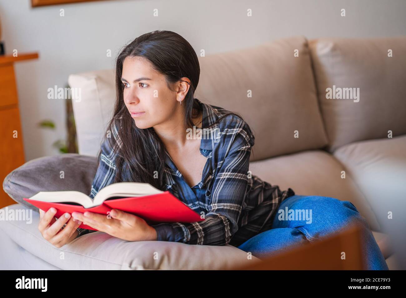 Young Woman reading book at home Stock Photo