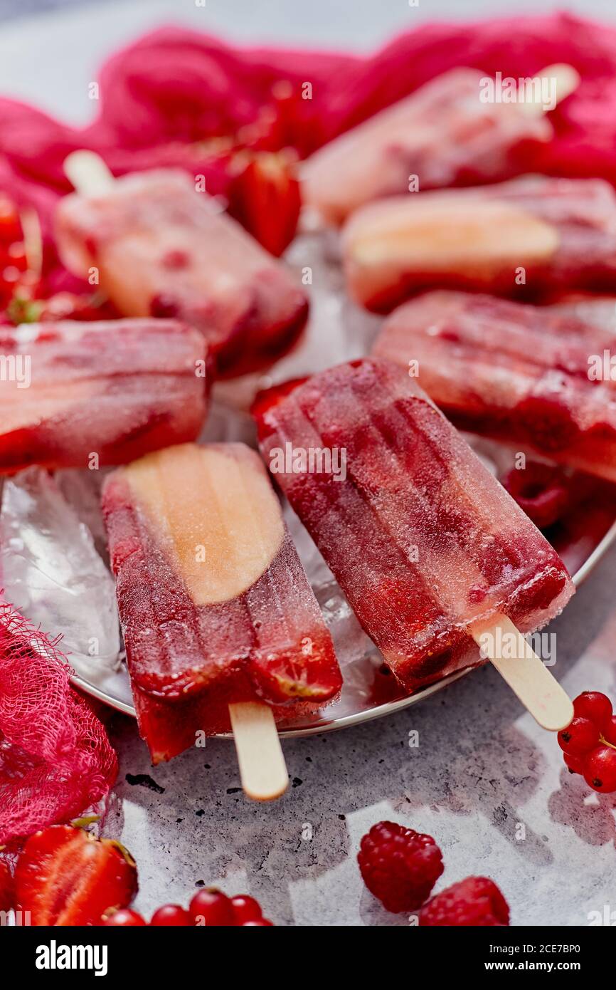 Strawberry raspberry apple and red currant ice cream popsicles in metal ...