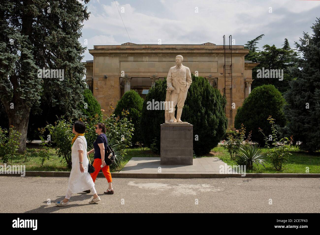 Gori, Georgia. 22nd July, 2019. Passers-by pass a monument to Joseph Stalin in front of the Stalin Museum. (to dpa 'Delicate memory: Where dictators were at home') Credit: George Gogua/dpa/Alamy Live News Stock Photo