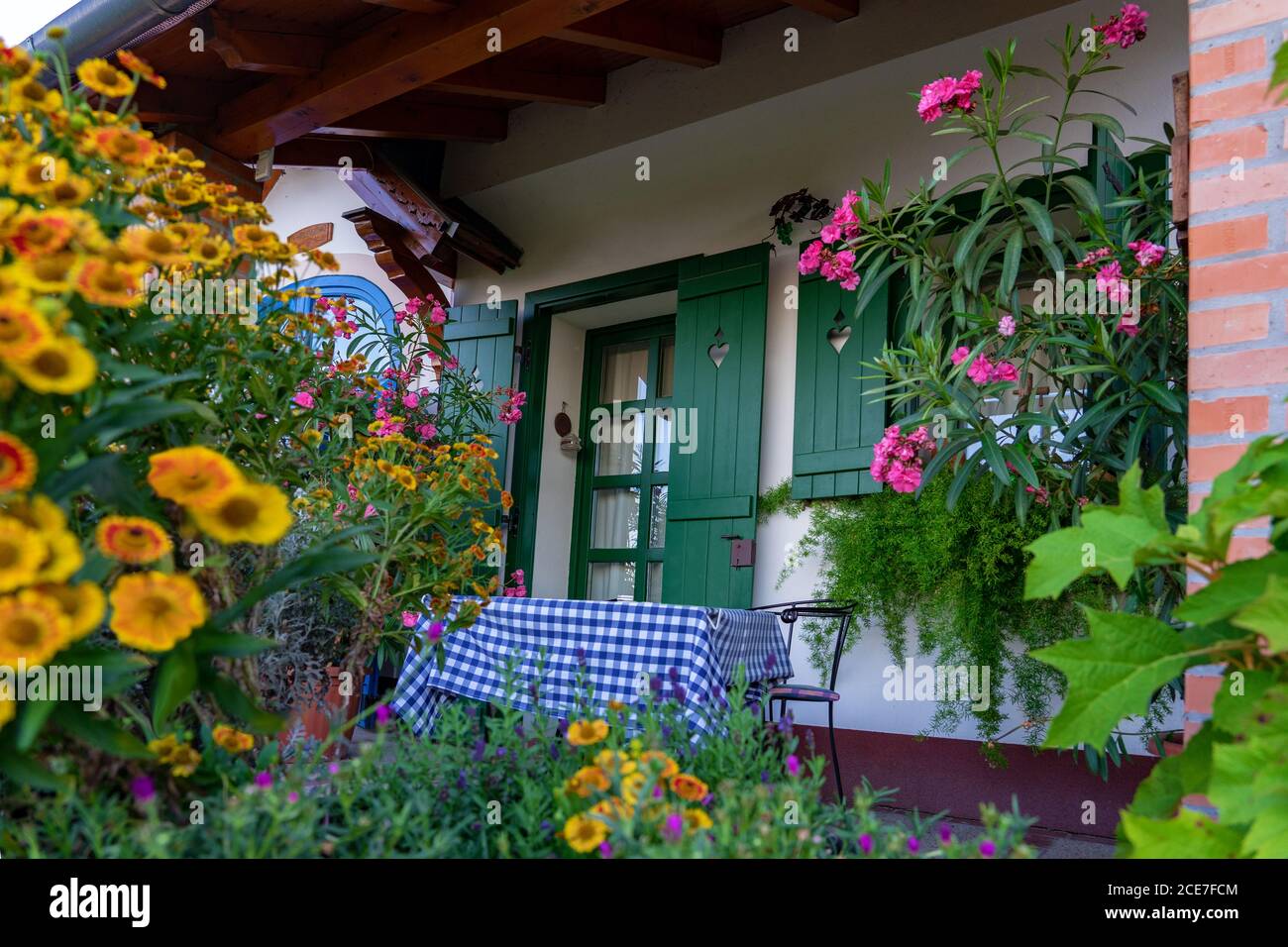 Colorful house entrance in Pecs Hungary with many flowers Stock Photo